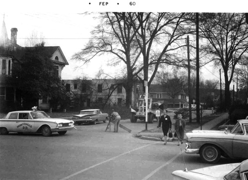 Police block off Middle Street for clean-up of tree tops as the large trees downtown were removed for street widening, 1960. Rogan house at left, Alabama Hotel and Cafe was next door. 